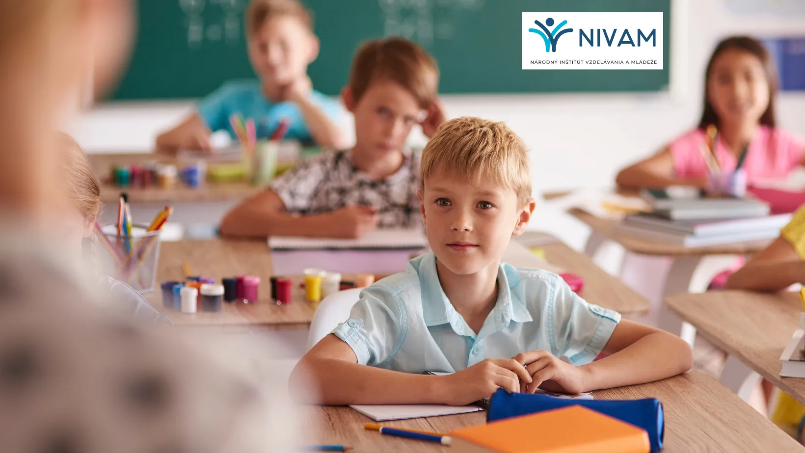 Na fotke žiak sediaci v lavici